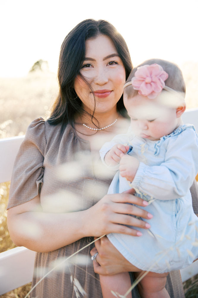 Mother holding her baby outdoors in soft natural light, one of the best locations for family photos in Sacramento