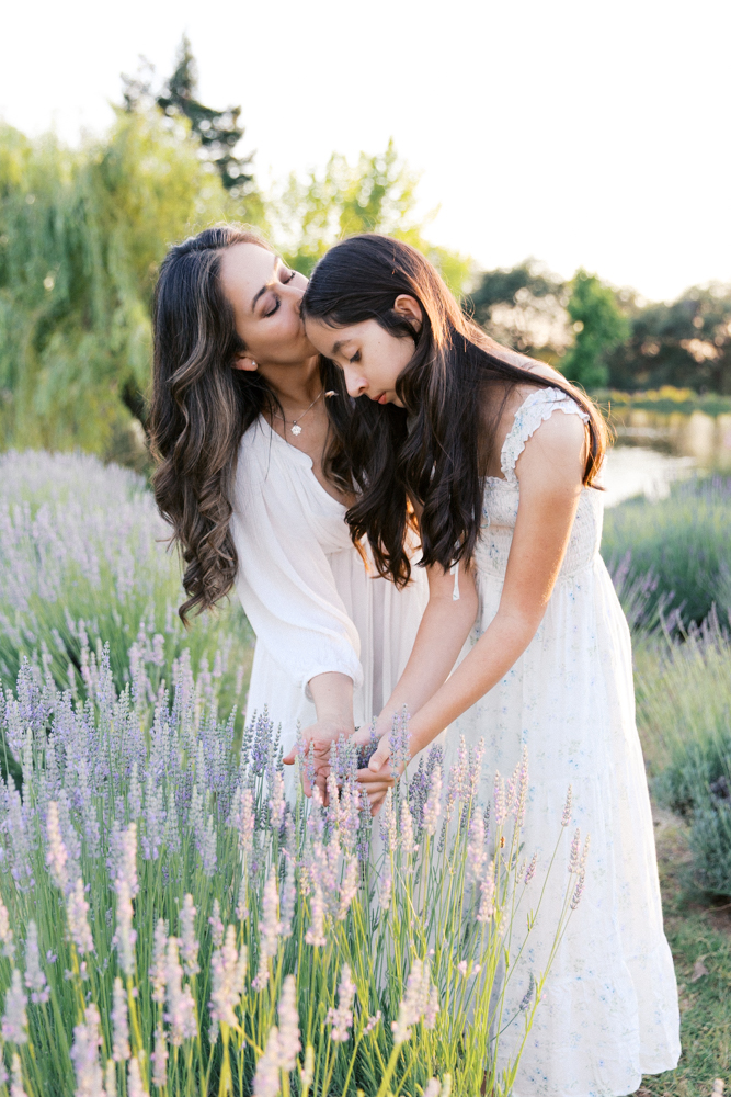 Mother and daughter walking together through a lavender field, one of the best locations for family photos in Sacramento