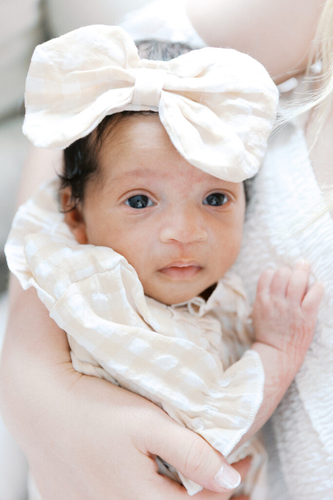 baby with a bow and eyes wide open