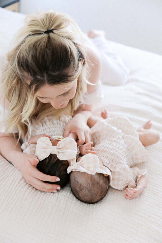mom looking at her twin baby girls