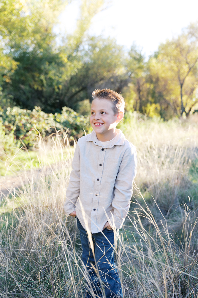little boy in tall grass